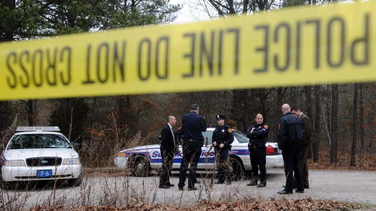 Police gather at Manorville Hills County Park, where a body...