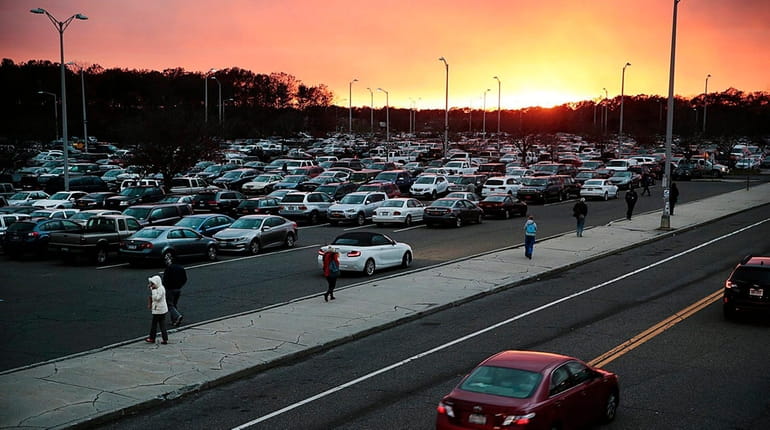 Commuters return to their cars in the crowded south parking...