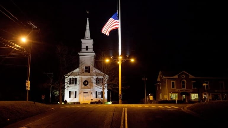 An American flag flies at half-staff on Main Street in...