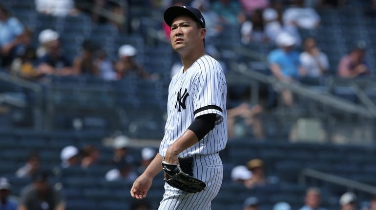 Yankees starting pitcher Masahiro Tanaka (19) reacts during the sixth...