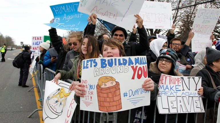 Protesters rally outside Grumman Studios in Bethpage, where Donald Trump...