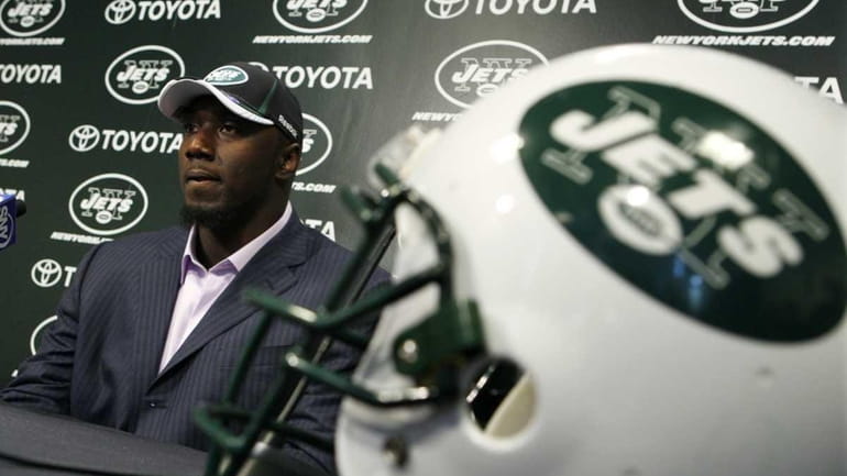 New York Jets draft pick Muhammad Wilkerson listens to a...