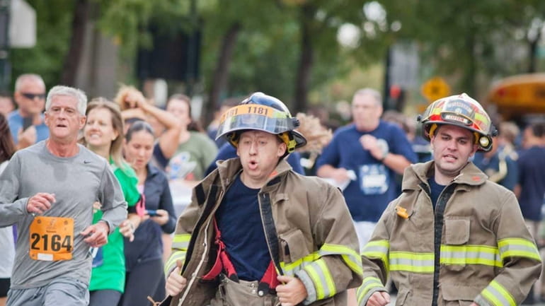 Two firefighters approach the finish line of the Stephen Siller...