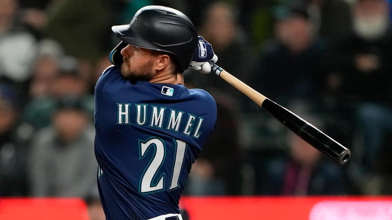 Seattle Mariners' Cooper Hummel swings against the Cleveland Guardians during...