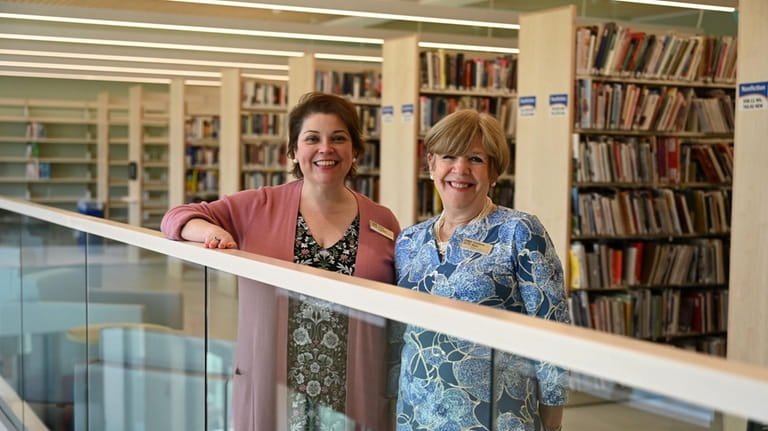 Half Hollow Hills library director Helen Crosson, left, and assistant...