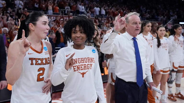 Texas guard Rori Harmon, second from left, stands with teammate...