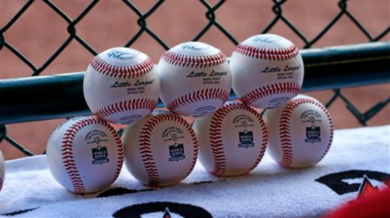 A pile of Little League baseballs wait to go be...