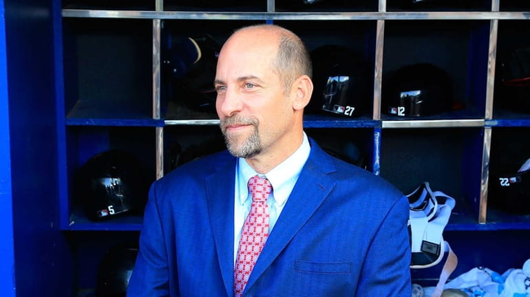 Former Atlanta Braves pitcher John Smoltz stands in the dugout...