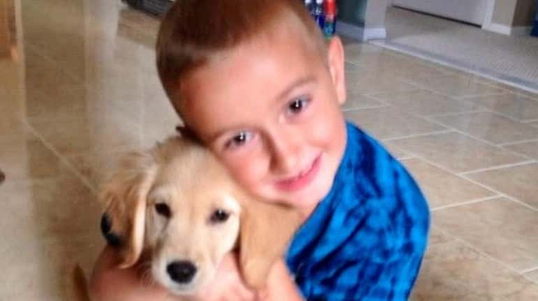 Kidsday reporter Brayden Elenterio hugs his dog,  Brody.