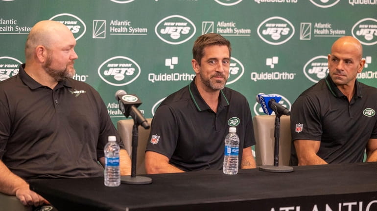 Jets quarterback Aaron Rodgers is introduced as he sits with...