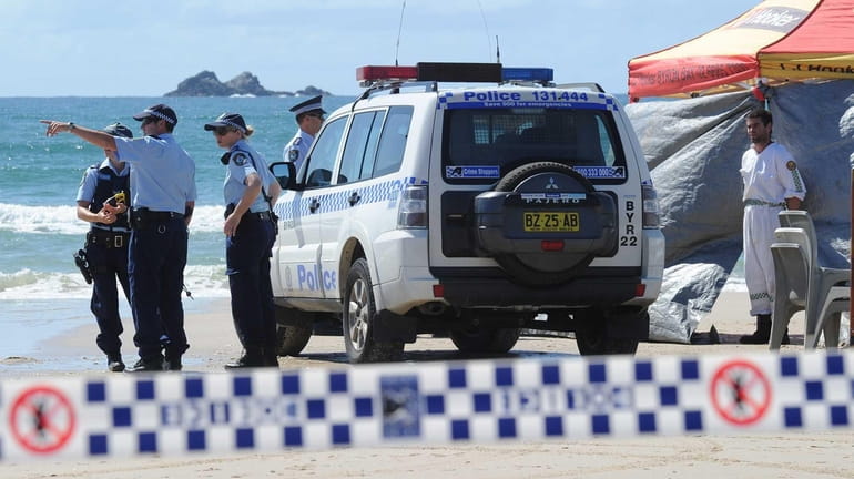 Members of the Australian Police inspect Clarkes Beach, at Byron...