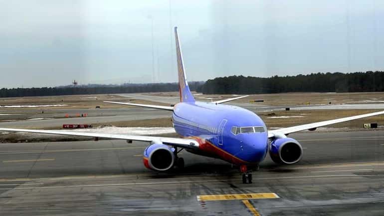 A Southwest airliner taxis to the terminal at Long Island...