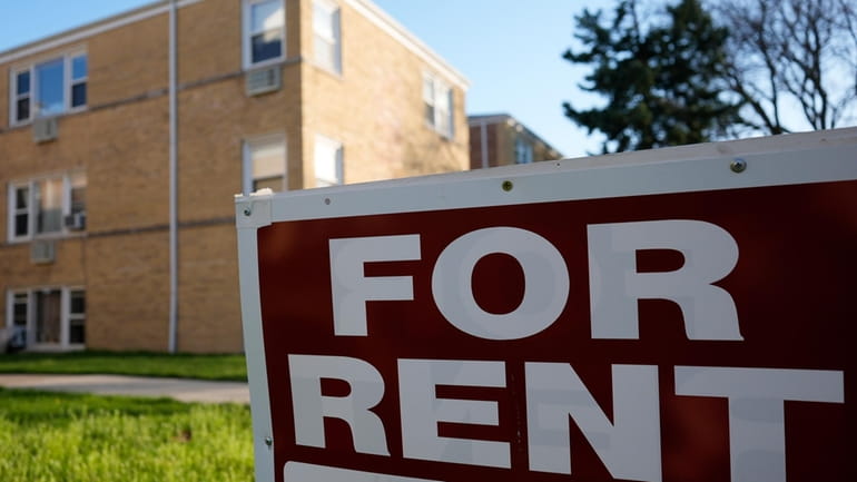 A "For Rent" sign displays outside apartment building in Skokie,...