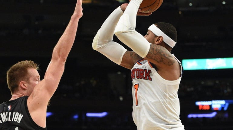 New York Knicks forward Carmelo Anthony attempts a three-point shot...