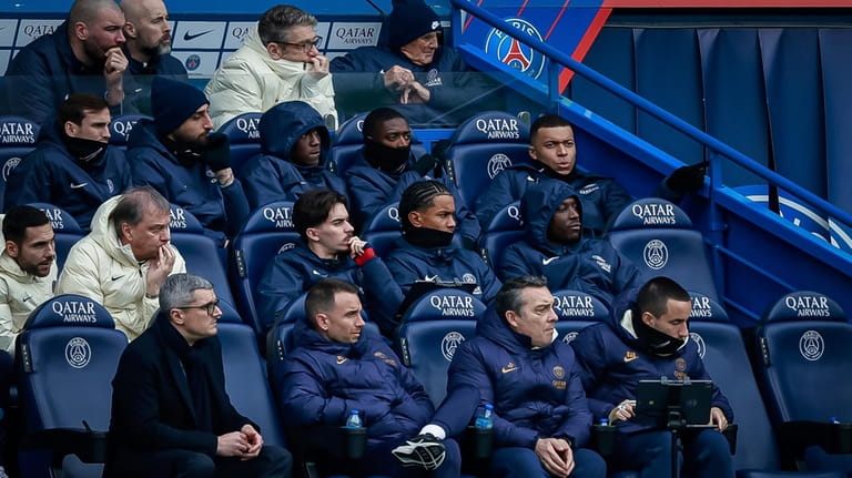 PSG's Kylian Mbappe sits on the substitutes bench during the...