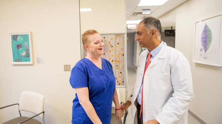 Patient Donna O'Rourke of Huntington Station greets Dr. Faisal Siddiqui,...