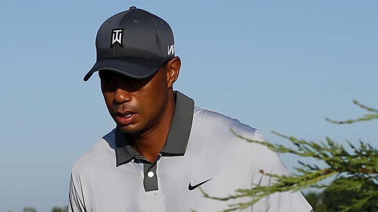 Tiger Woods walks to the second hole during a practice...