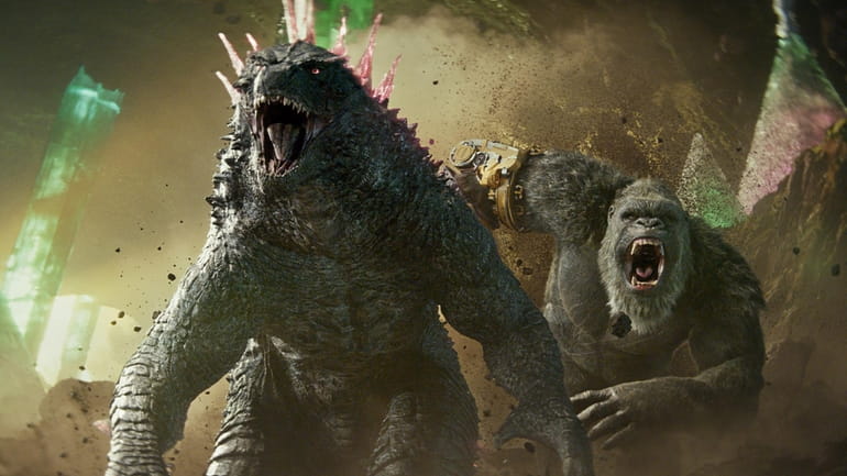 This image released by Warner Bros. Pictures shows Godzilla, left,...