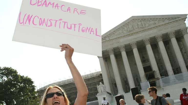 A woman protests against the Obama administrations health care plan...