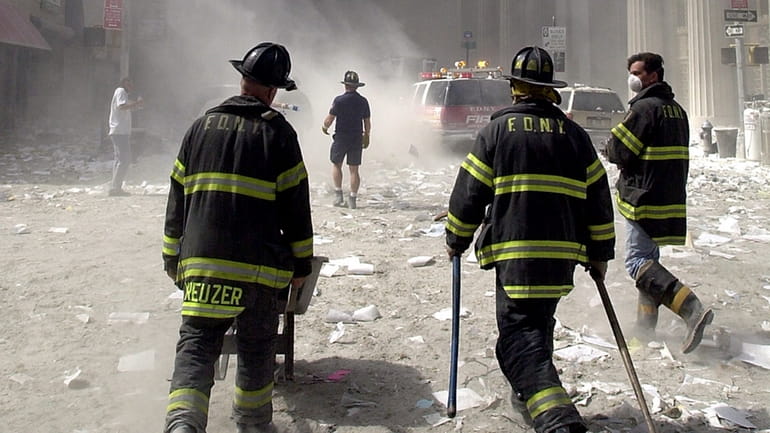 Firefighters head toward the World Trade Center site after the collapse...