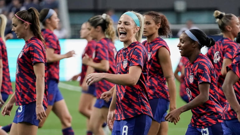 U.S. midfielder Julie Ertz, center, laughs while warming up with...