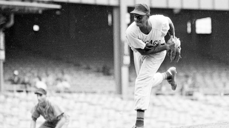 Satchel Paige pitches from the mound during a Negro Leagues...
