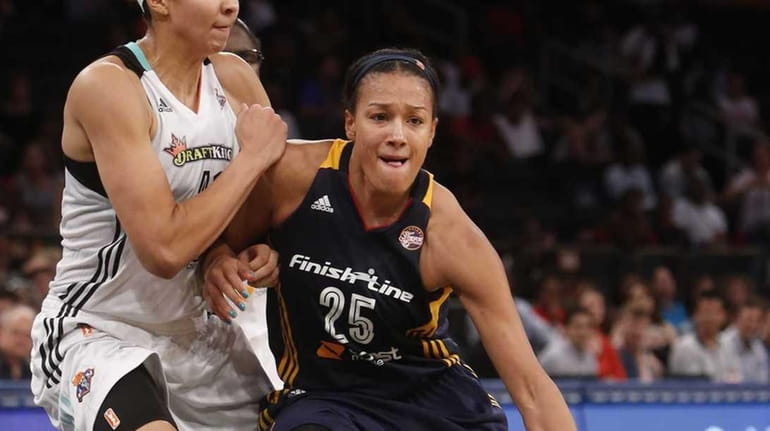 Marissa Coleman of the Indiana Fever drives to the basket...