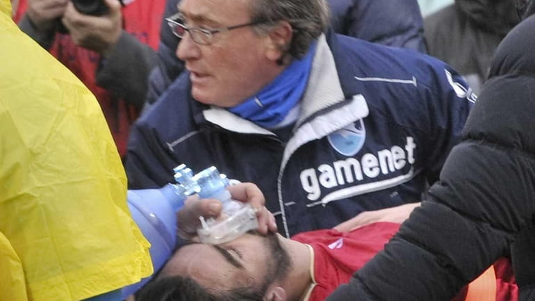 Medics assist Livorno's Piermario Morosini at the Pescara's Adriatico stadium,...