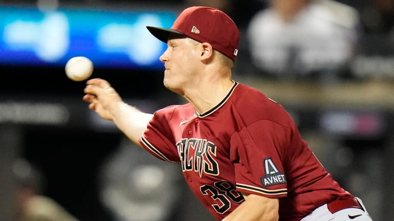 The Diamondbacks' Paul Sewald pitches during the ninth inning of...