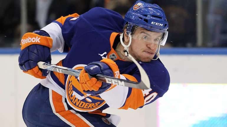 The Islanders' Michael Grabner shoots the puck in the first...
