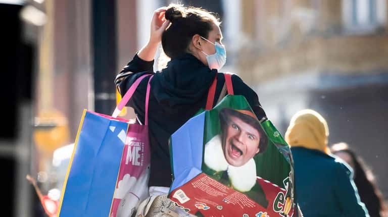 A woman wears a mask while shopping Wednesday in Leeds City Centre,...