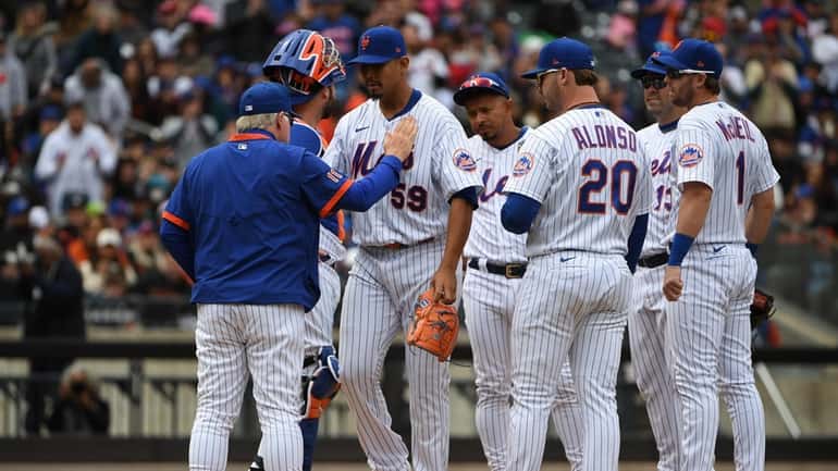 New York Mets manager Buck Showalter taps starting pitcher Carlos...