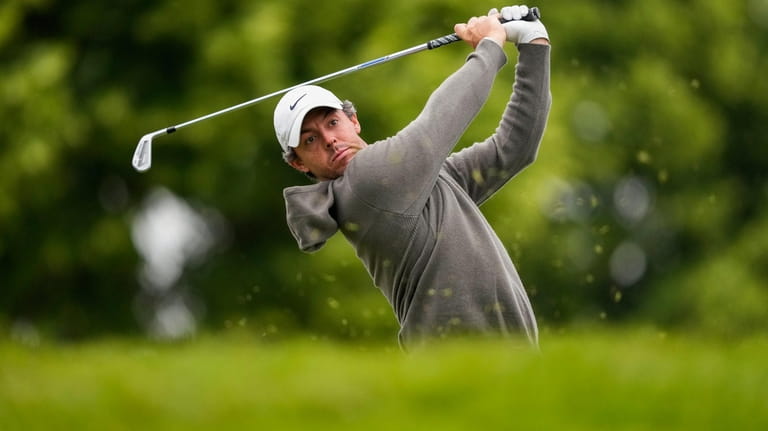 Rory McIlroy tees off on the 10th hole during the...