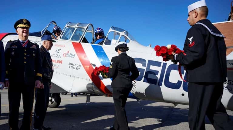 The Long Island Air Force Association presents roses to be dropped...