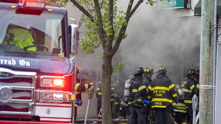 Firefighters battle the blaze in Floral Park on Monday.