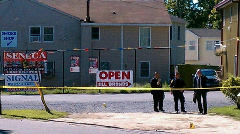 Police investigate the scene of a shooting on the Poospatuck...