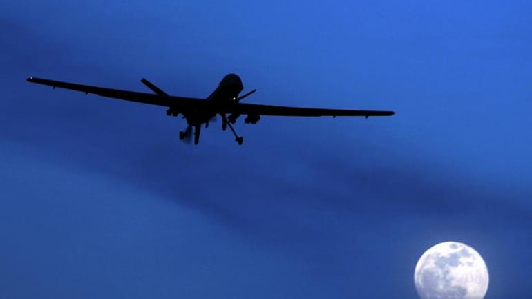 An unmanned U.S. Predator drone flies over Kandahar Air Field,...