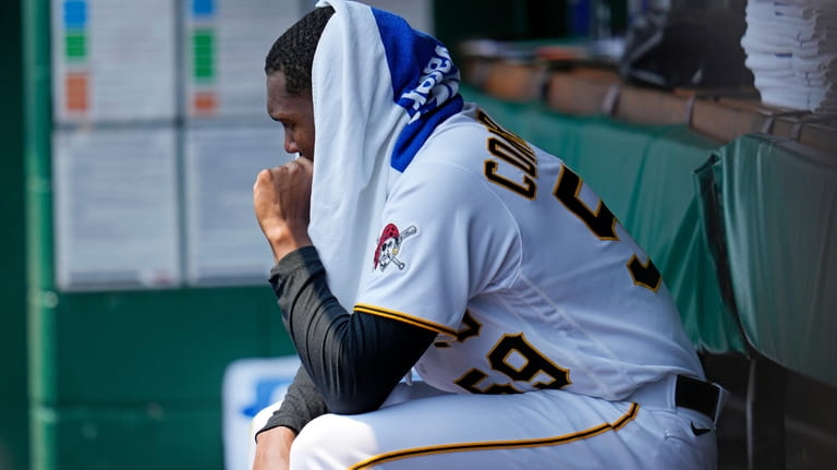 Pittsburgh Pirates starting pitcher Roansy Contreras sits in the dugout...