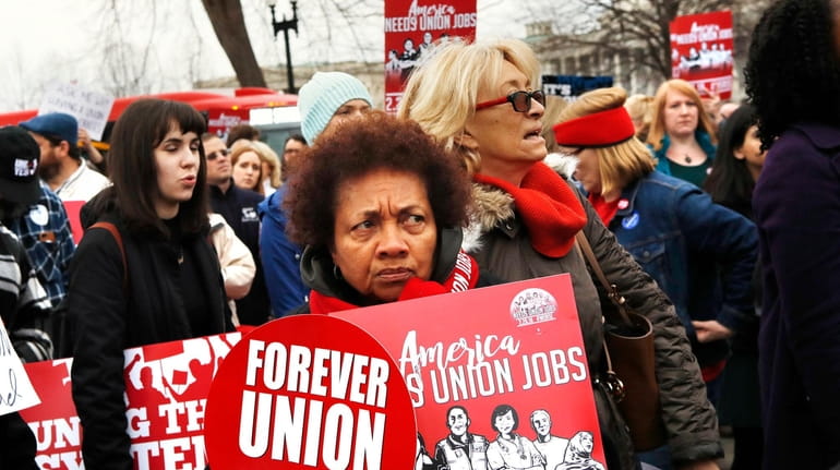 Betty Shadrick, center, with the United University Professions union, rallies in...