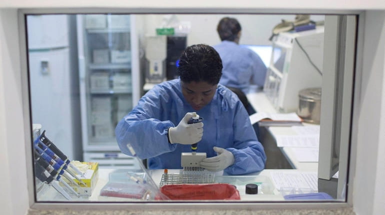 A graduate student analyzes samples to identify the zika virus...