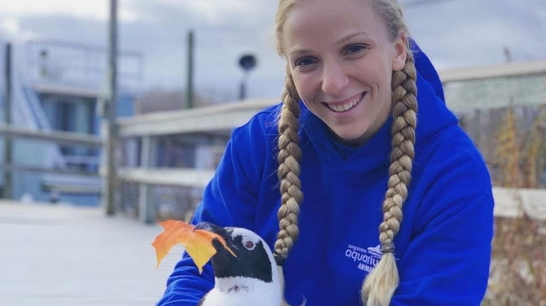 Long Island Aquarium staffer Elena Zanzarov with a penguin.