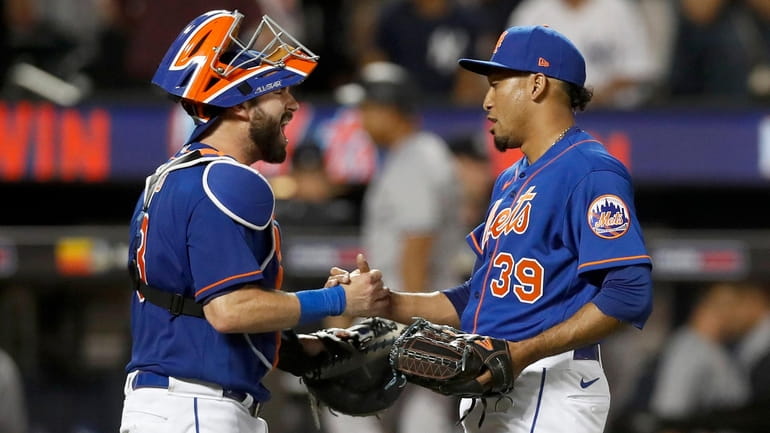 Edwin Diaz and Tomas Nido of the Mets celebrate after defeating...