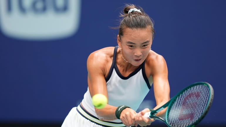 Yue Yuan, of China, returns a ball from Maria Sakkari,...