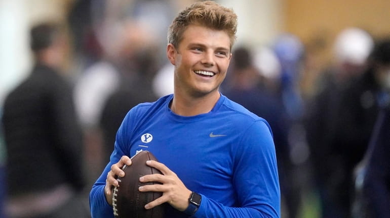 BYU quarterback Zach Wilson warms up before participating in the...