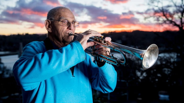 Stanley Wertheimer, 86, plays taps from his hill overlooking Centerport...