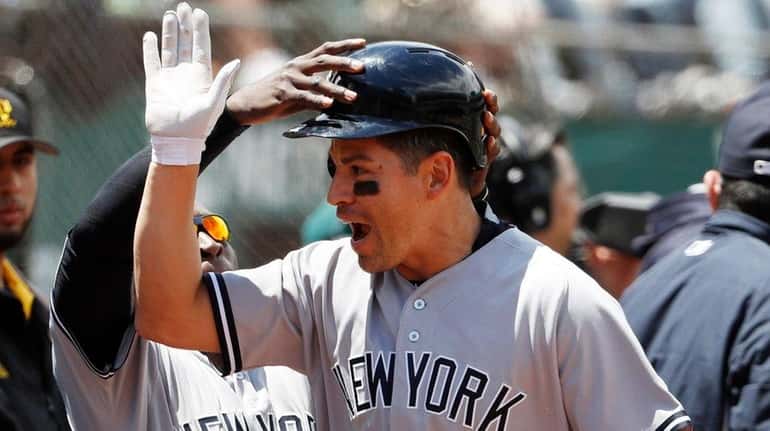 Jacoby Ellsbury of the New York Yankees is congratulated by...