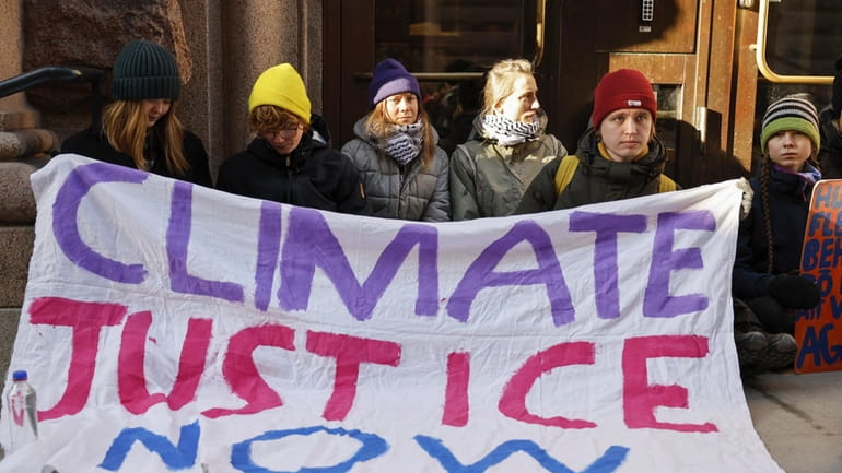 Climate activist Greta Thunberg, third from left, and other protesters,...