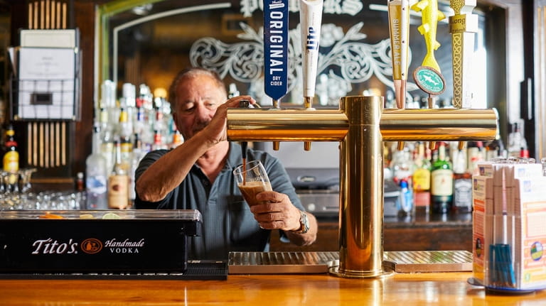 John Bearese pours a guinness at Buckley's Irish Pub in Center...