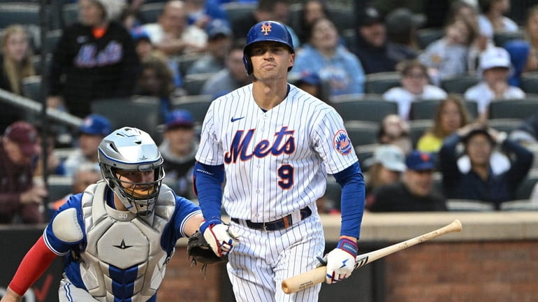 New York Mets' Brandon Nimmo reacts after he struck out...