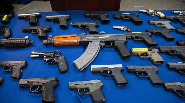 Some of the153 guns seized in Brooklyn between May and...